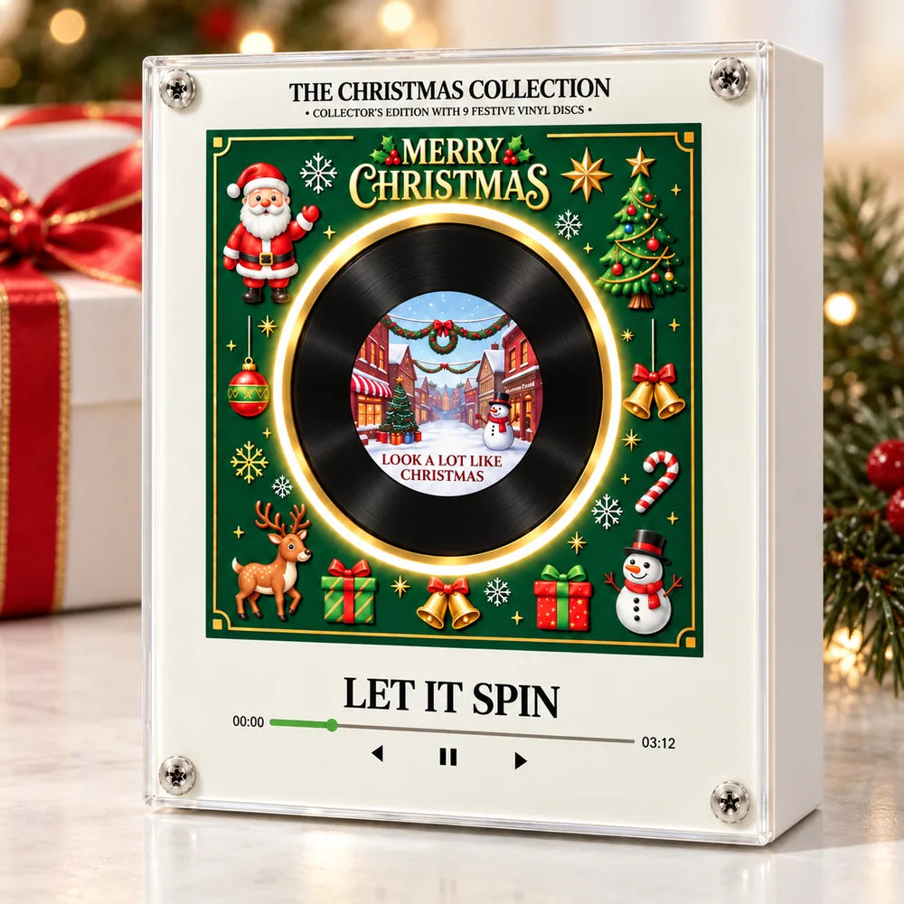 Christmas music player beside a wrapped gift and a lit tree